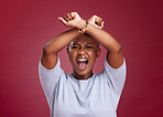 Black woman, shouting and protest to stop racism or discrimination against a red studio background. Angry African American female voice with arms crossed on strike or fight for human rights on mockup