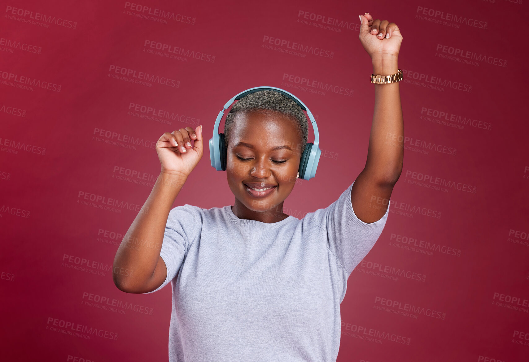 Buy stock photo Music, dance and freedom with a black woman in studio on a red background for dancing or fun. Dancer, headphones and carefree with a young female streaming audio with an online service for enjoyment