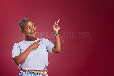 Buy stock photo Black woman, mockup and pointing for advertising, marketing or banner against a studio background. Happy African American female point to empty copyspace for sale advertisement text, message or brand