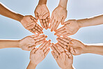 Hands in circle, teamwork or business people with support, collaboration or team building for mission success from below. Blue sky, diversity or community for vision, partnership or corporate goal.