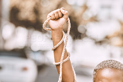 Buy stock photo Hand, rope and fist protest slavery for freedom and human rights against an urban background. Activist, activism and rebellion against racism and change for civil, law and government rights 