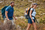 Hiking, blurred motion and adventure with a couple in the mountain for health, exercise or fitness together. Nature, training and love with a man and woman walking in the mountains while bonding