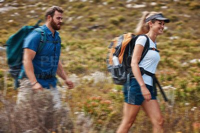 Buy stock photo Hiking, blurred motion and adventure with a couple in the mountain for health, exercise or fitness together. Nature, training and love with a man and woman walking in the mountains while bonding