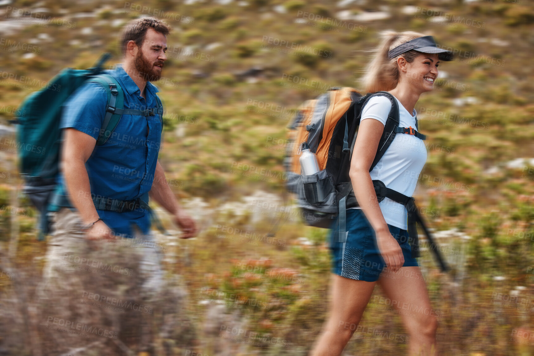 Buy stock photo Hiking, blurred motion and adventure with a couple in the mountain for health, exercise or fitness together. Nature, training and love with a man and woman walking in the mountains while bonding