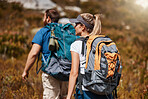 Hiking, fitness and adventure with a couple in nature for exercise or a weekend getaway in summer. Forest, mountain and travel with a man and woman walking outdoor for health or freedom together