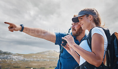Buy stock photo Pointing, travel and couple hiking on the mountains in a natural environment for an outdoors adventure in Canada. Freedom, lifestyle and healthy woman loves walking or trekking with partner in nature