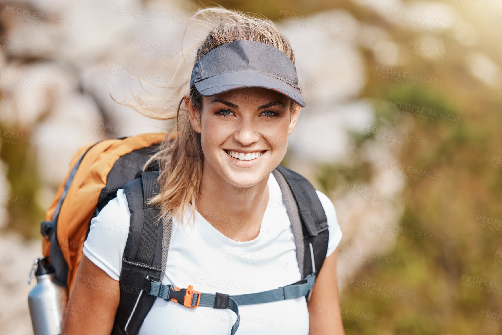 Buy stock photo Hiking, fitness and exercise with a woman in the mountains, walking during a sunny summer day. Portrait, nature and health with a young female outdoor for a walk alone on a natural mountain trail