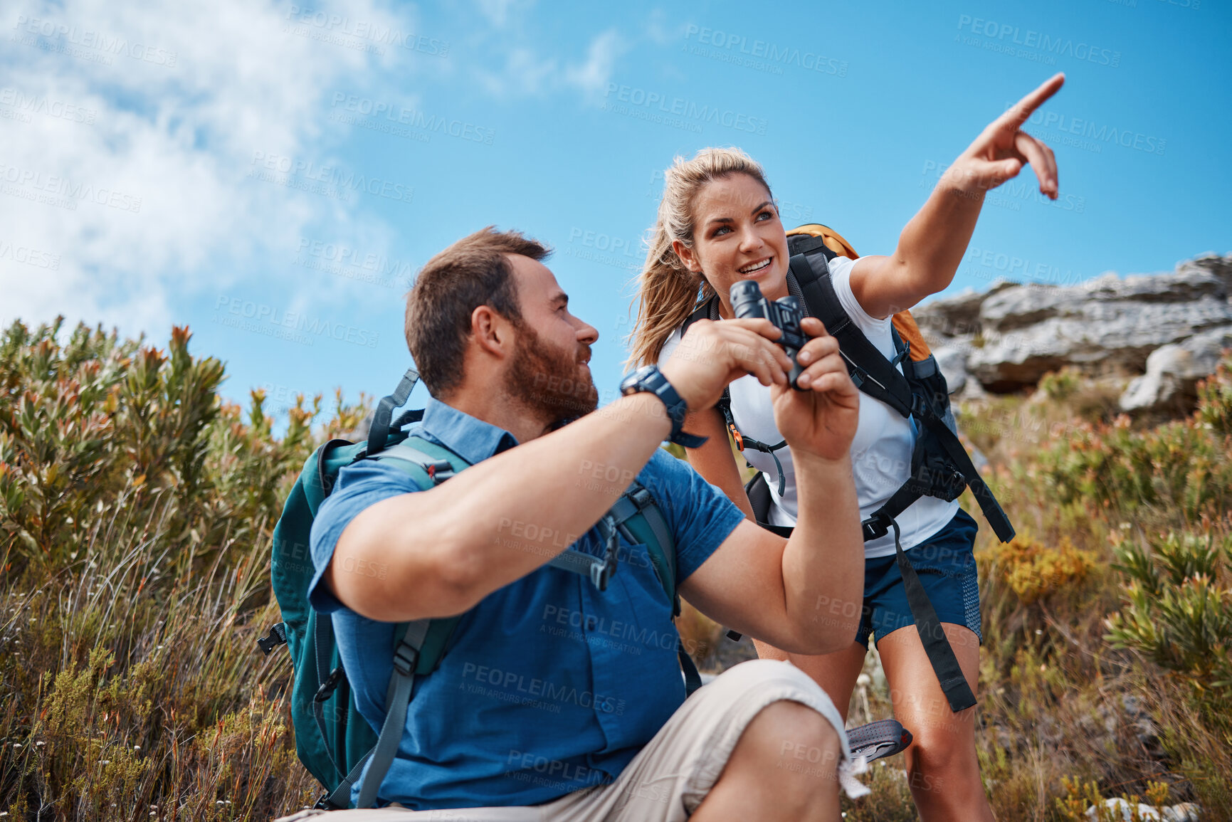 Buy stock photo Hiking, couple and in nature to relax, talking and enjoy the outdoor view for fresh air. Health, man and woman point have speaking with tourist, mountain range or vacation with binocular and wellness