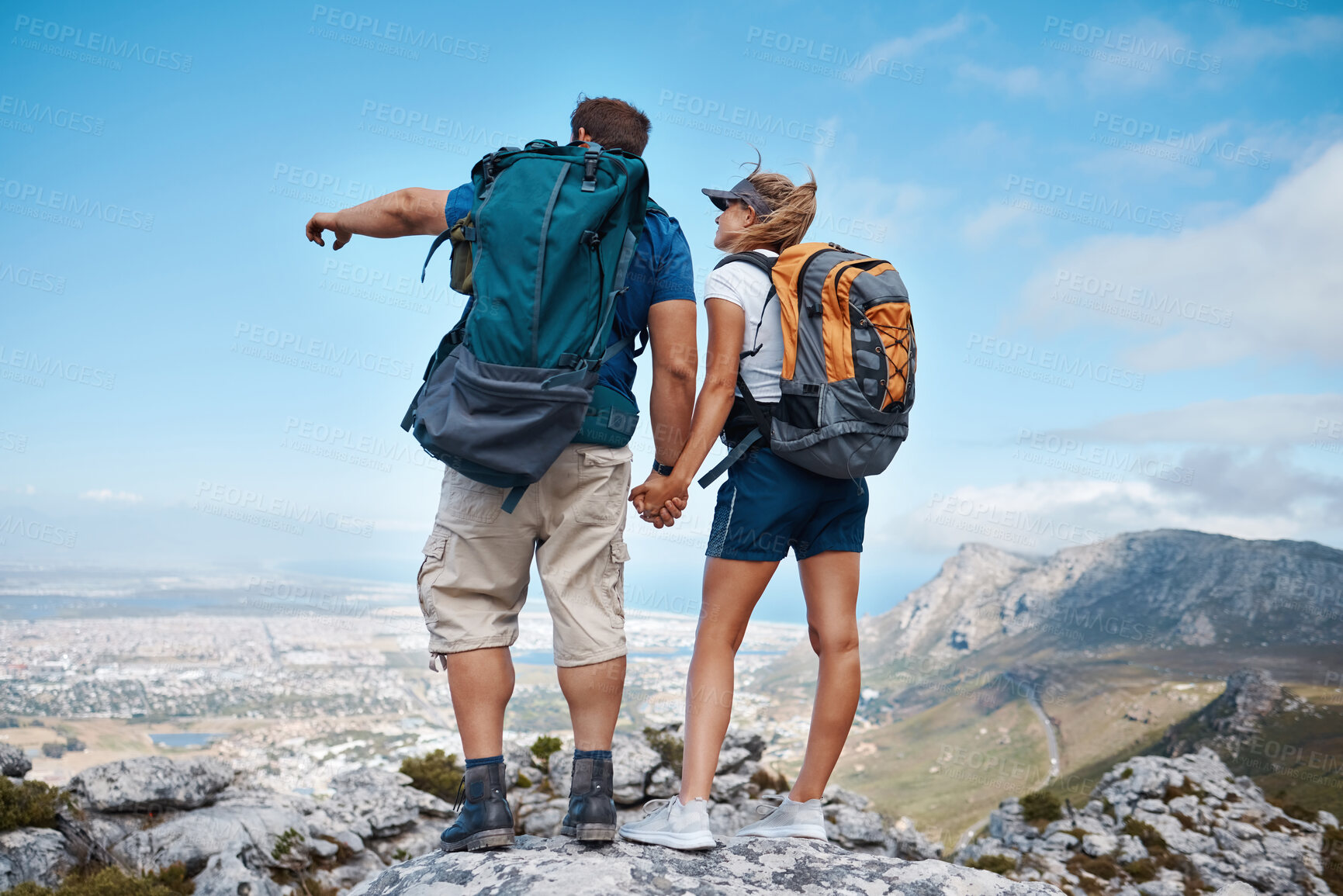 Buy stock photo Hiking, view and fitness with a couple in the mountains for health, exercise or sightseeing together in summer. Earth, nature and travel with a man and woman holding hands on a mountain trail or peak