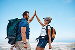 Hiking, high five and happy couple on an adventure in nature while on summer vacation in South Africa. Happiness, freedom and friends trekking on an outdoor trail for exercise on holiday or journey.