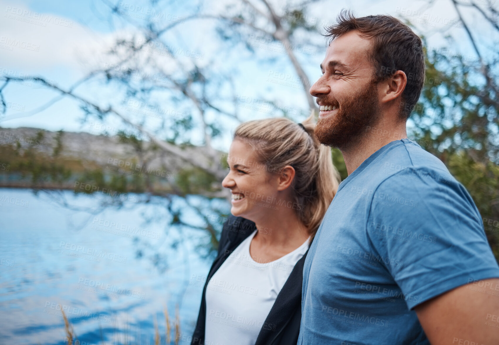 Buy stock photo Couple, smile and lake in nature for camping, bonding and morning view with happiness outdoor. Man, woman and happy by calm water together on vacation, adventure or holiday for rest, relax and peace