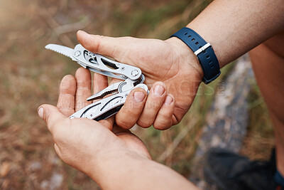 Buy stock photo Hands, man or multi purpose knife in environment camping land, sustainability forest woods or hiking mountains. Zoom, hiker or swiss army blade, survival tools or metal equipment gear in nature earth