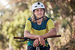 Bicycle, fitness and athlete cycling in a forest training, cardio exercise and sports workout outdoors in nature. Biker, young and healthy male teenager enjoys traveling on a fun adventure journey 