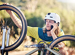 Phone call, bike and fitness with a man cyclist talking using 5g mobile technology while outdoor in the forest for exercise. Contact, nature and cycling with a young male athlete on a bicycle ride