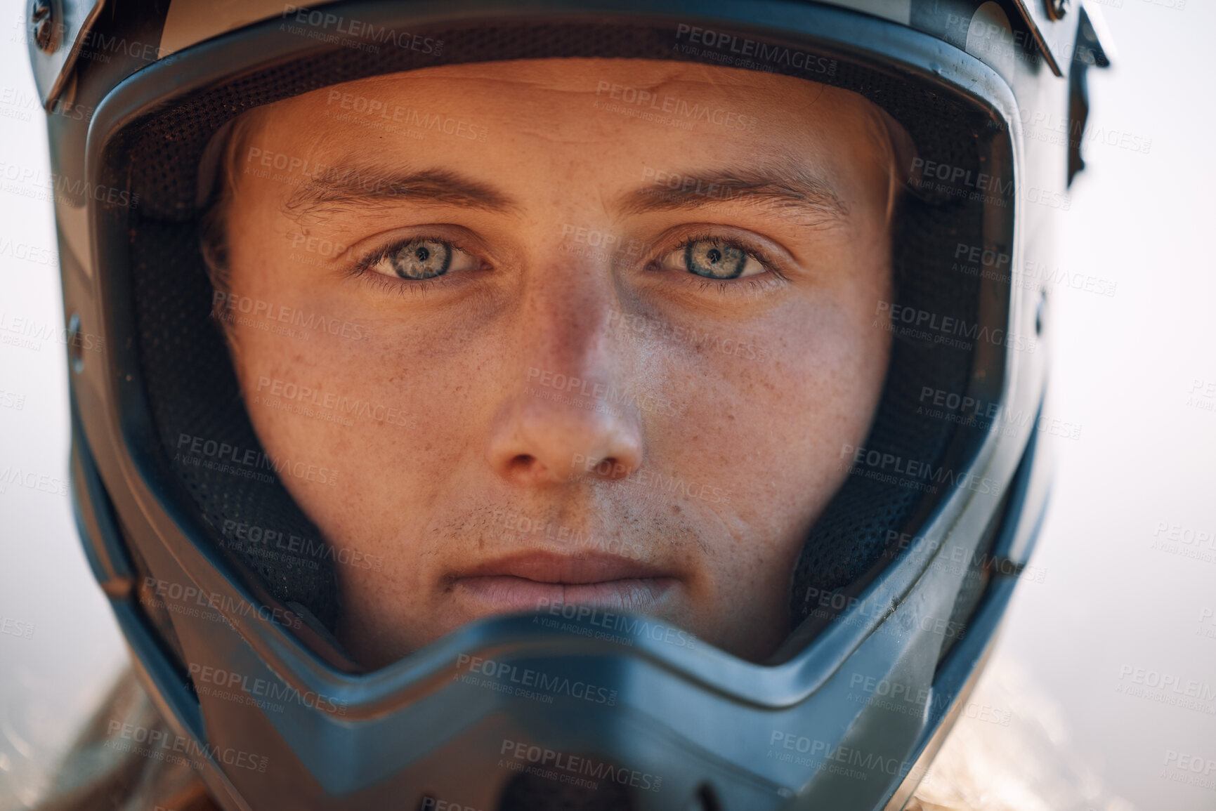 Buy stock photo Face, helmet and extreme sports with a man biker outdoor alone for adventure or adrenaline. Portrait, safety and motocross with a confident male rider outside alone for fun or recreation closeup