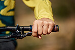 Hand, handle and bike with a man athlete or cyclist riding outdoor for fitness, exercise or cardio. Workout, health a grip with a male bicycle rider holding on a handlebar while outdoor for endurance