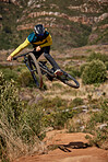 Jump, mountain bike and cyclist performing extreme sport stunt on his bike. Adrenaline, fitness and biking man riding while jumping for competitive racing competition to keep active with cardio 