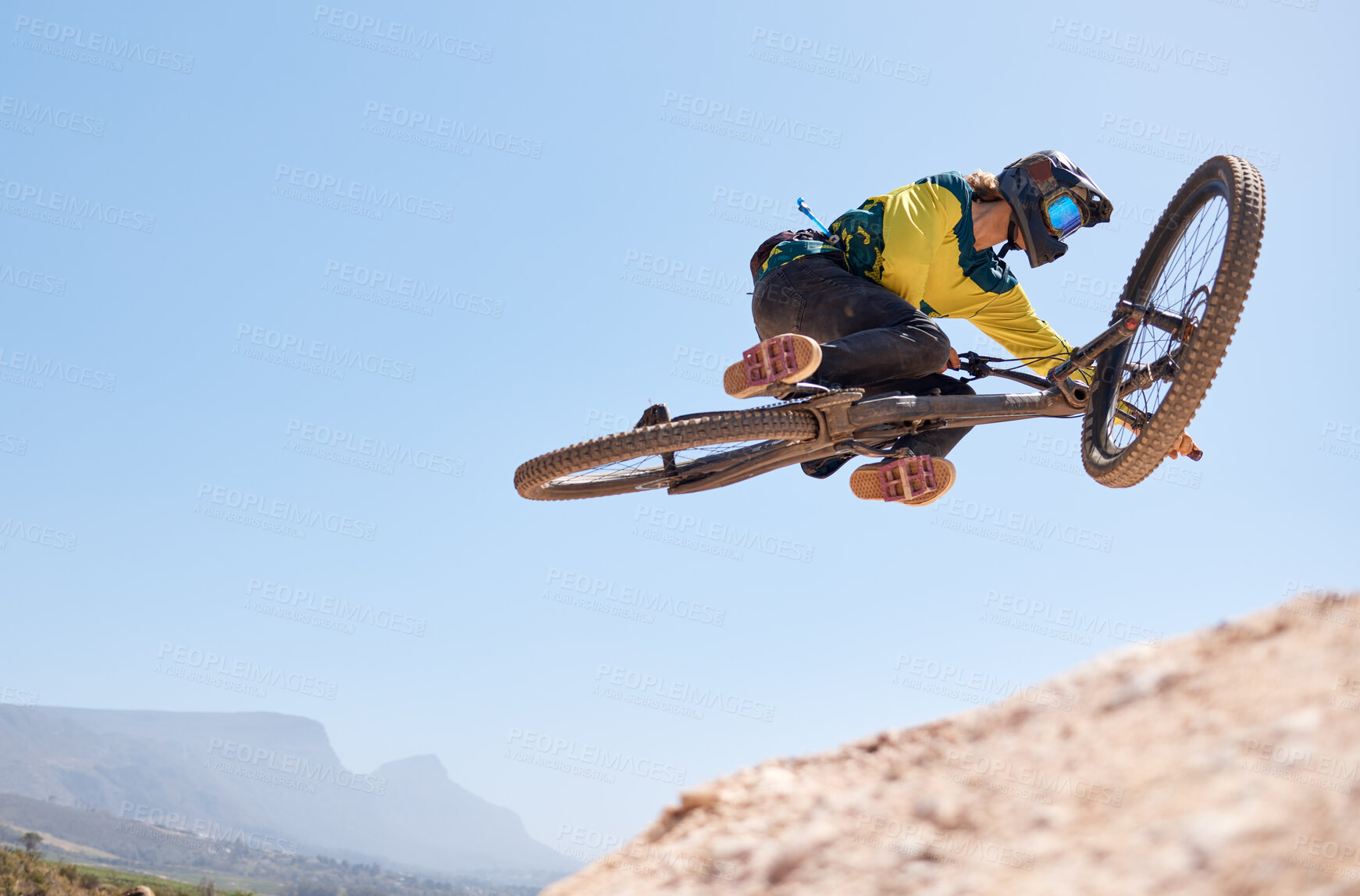 Buy stock photo Nature, cycling and man jump with bike in air stunt, performance and outdoor sport exercise in Canada. Mountain bike, adventure and fitness of person with flying action on bicycle with sky mockup.
