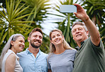 Phone, family and selfie with a man, woman and inlaws posing for a picture together in a garden or yard outdoor. Mobile, happy and smile with a senior father, mother and relatives taking a photograph