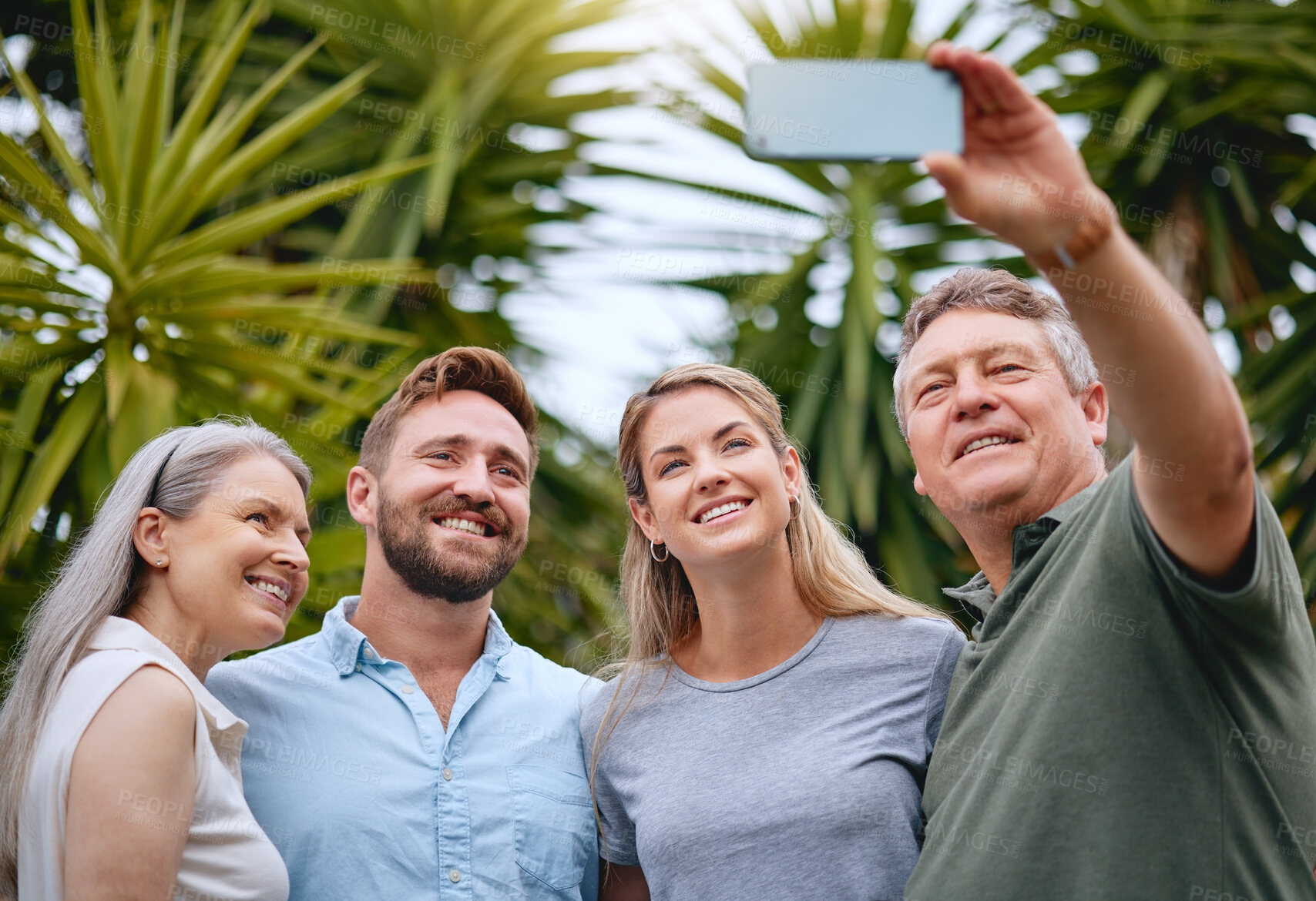 Buy stock photo Phone, family and selfie with a man, woman and inlaws posing for a picture together in a garden or yard outdoor. Mobile, happy and smile with a senior father, mother and relatives taking a photograph