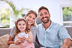 Happy, relax and parents with a child and peace, calm and love on the living room sofa in a house. Smile, bonding and portrait of girl kid with her loving mother and father on the couch in their home