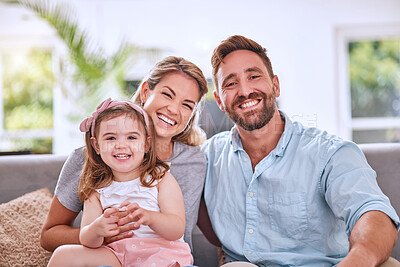 Buy stock photo Happy, relax and parents with a child and peace, calm and love on the living room sofa in a house. Smile, bonding and portrait of girl kid with her loving mother and father on the couch in their home