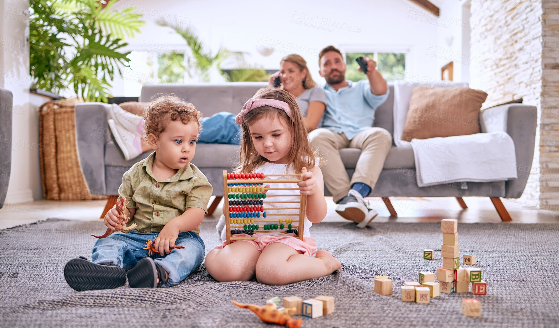 Buy stock photo Development, family and children with math toys and playing with building blocks in the house living room. Education, mother and relaxed father watching tv with kids or siblings learning from a game