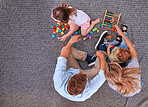 Family, children and learning with education toys, blocks and abacus for color game with mom and dad on floor. Man and women parents with kids for learning, development and playing on home carpet
