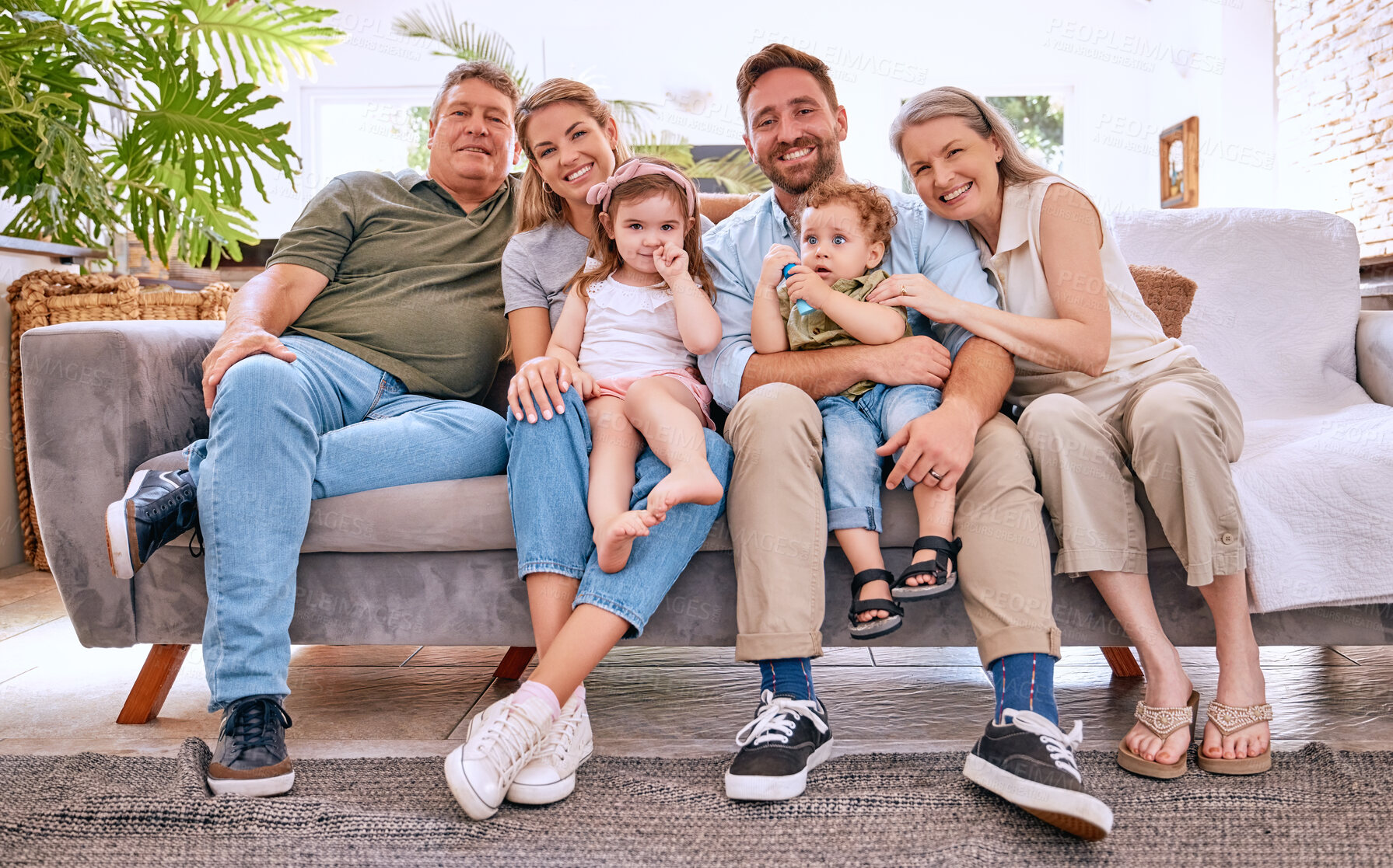 Buy stock photo Happy big family, relax and smile on living room sofa for quality bonding time together at home. Portrait of family smiling and relaxing on couch for lounge break, weekend or holiday at the house