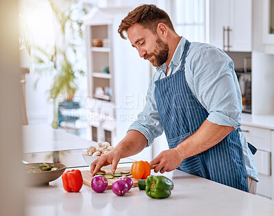 Buy stock photo Man, chef and cooking, cut vegetable in kitchen and healthy with diet, nutrition and vitamins preparing dinner or lunch meal. Food at home with apron and organic, fresh pepper and onion.