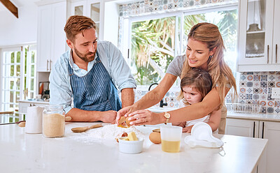 Buy stock photo Baking, child and parents teaching a child to bake in the kitchen of a house. Cooking, happy and mother and father helping a girl kid learning to make a cake, food or breakfast in their family home