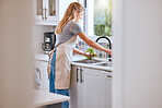 Woman, cooking and cleaning food or vegetable with water under kitchen tap for healthcare, wellness and safety home. Female chef or housewife with green lettuce for salad, lunch or dinner for diet