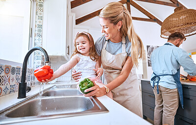 Buy stock photo Kid, washing vegetables and cooking with mother together with healthy food, nutrition and and diet for lunch, dinner and salad. Girl child helping mom cleaning pepper at running water in family home
