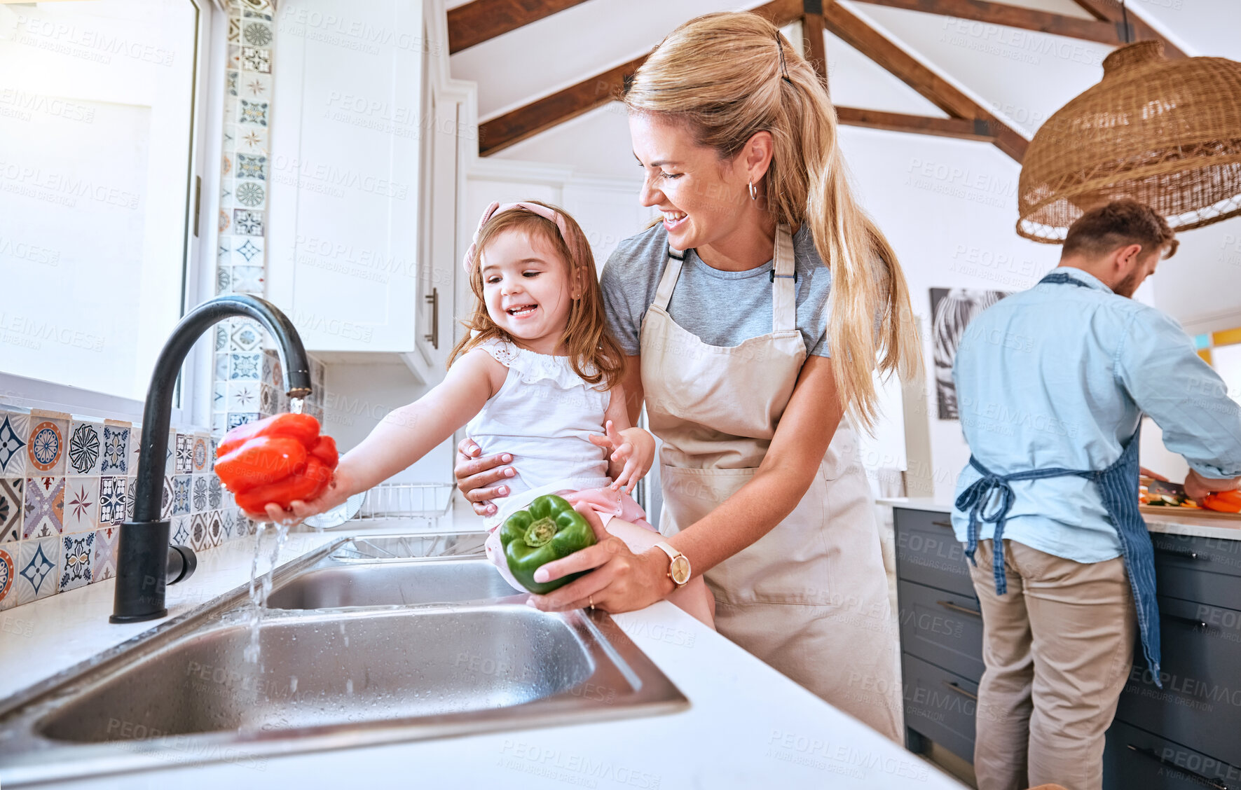 Buy stock photo Kid, washing vegetables and cooking with mother together with healthy food, nutrition and and diet for lunch, dinner and salad. Girl child helping mom cleaning pepper at running water in family home