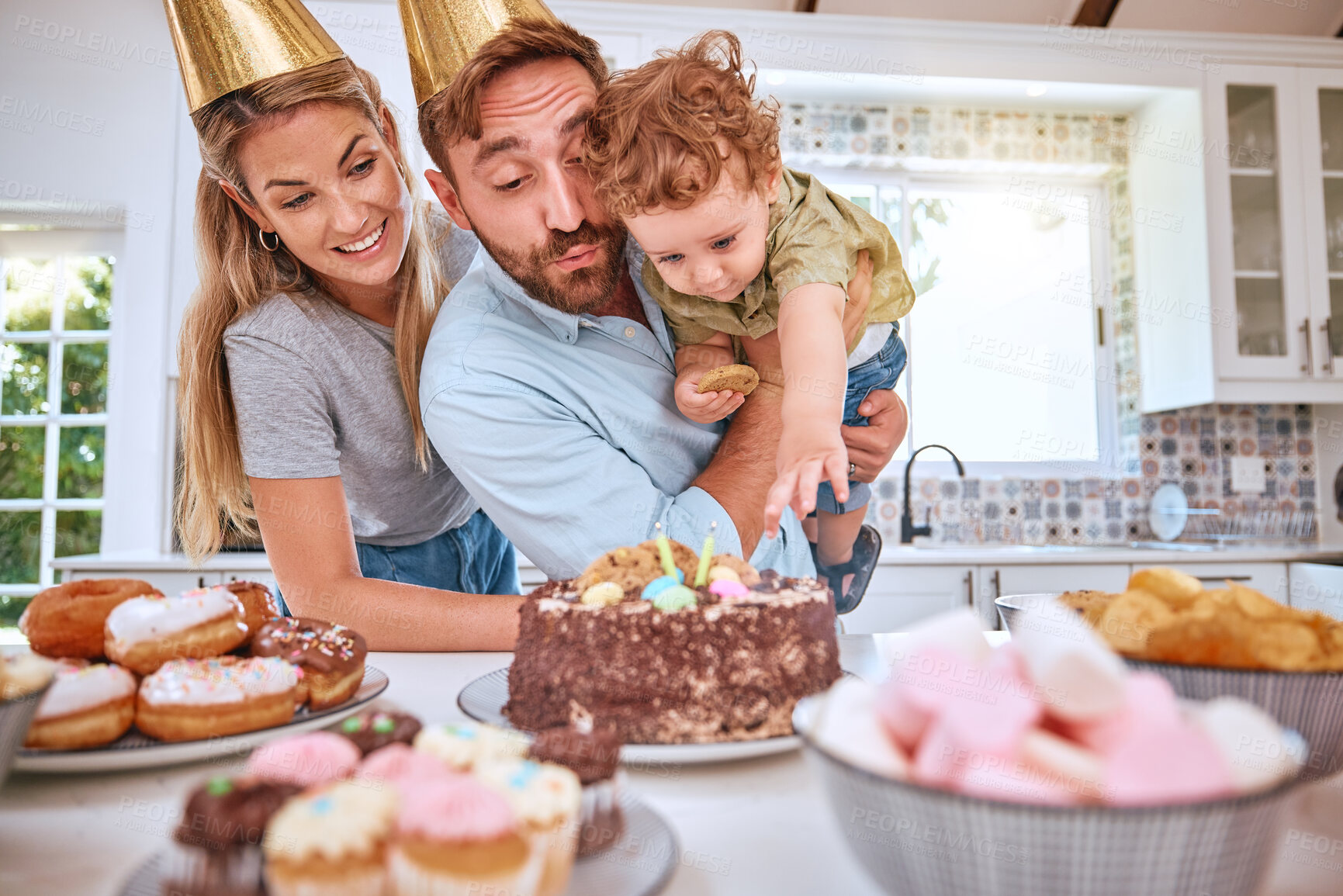 Buy stock photo Family, birthday and celebrating child with party and cake at home while having fun. Mother, father and little boy celebration with a birthday party, dessert and sweet candy for love and care