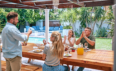 Buy stock photo Champagne, celebration and family with applause at lunch party with food, love and relax in garden of house. Wine, happy and man with alcohol at barbecue with woman and senior parents in a backyard