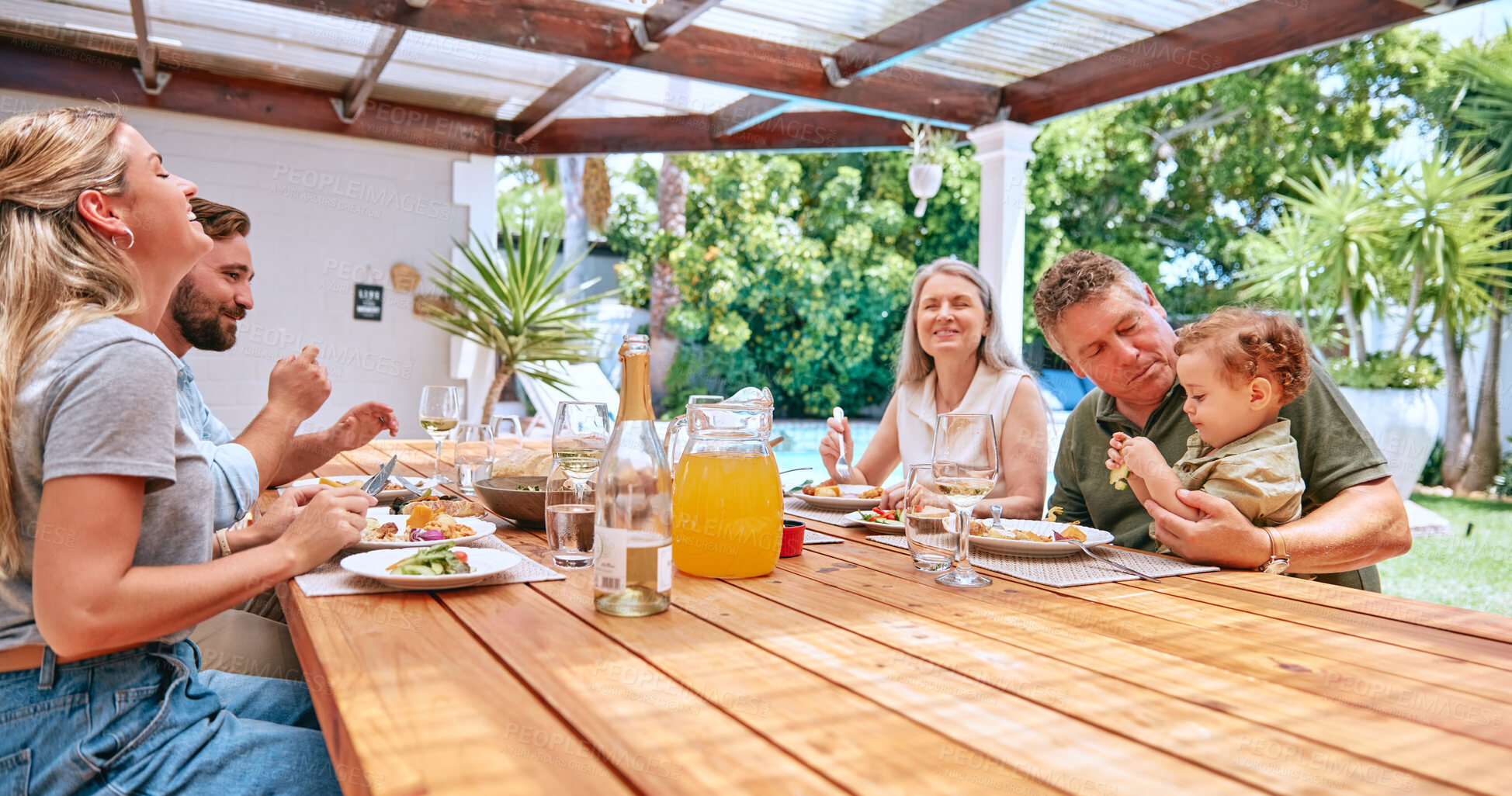 Buy stock photo Family, lunch and outdoor happiness of a mother, man and children with grandparents and kid care. Happy big family, kids and parents together bonding with barbecue food in summer eating with a smile