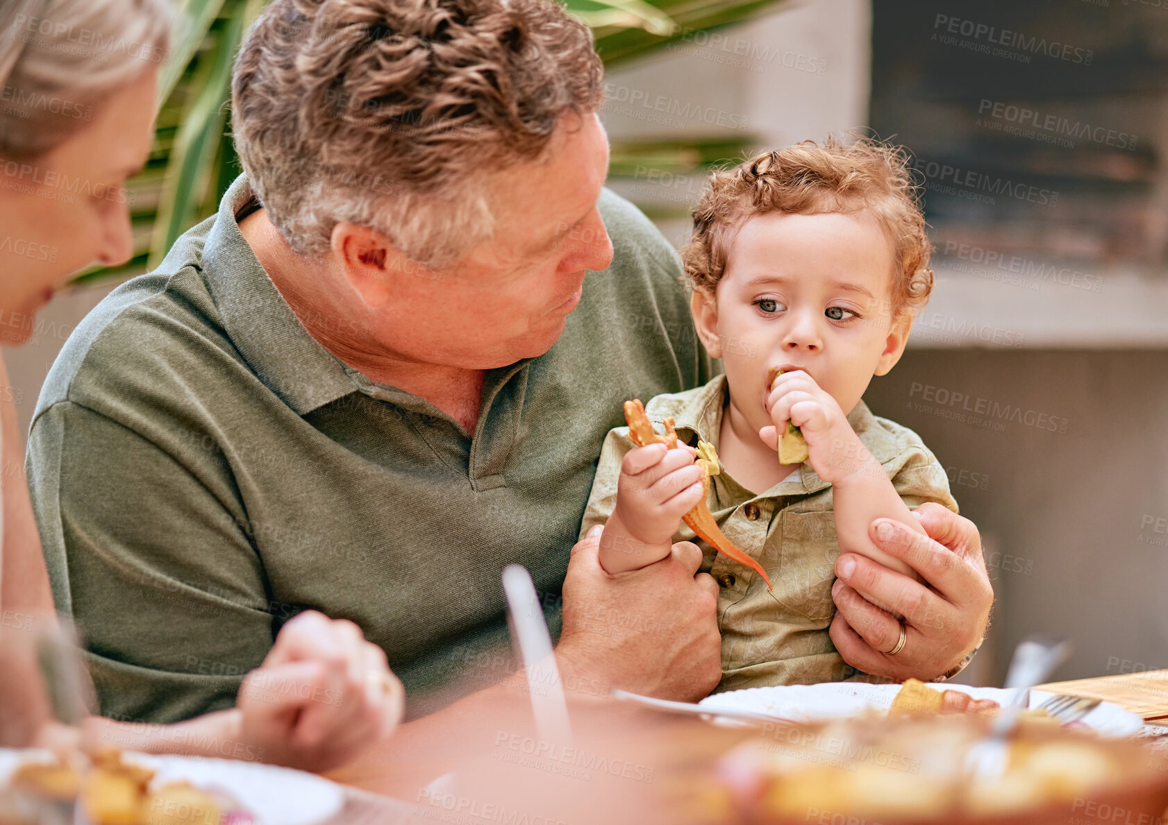 Buy stock photo Family, lunch and grandparents have food with child at home for happy bonding meal together. Senior grandmother, grandpa and young kid at family home eating at dining table in summer.

