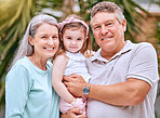 Garden, family and grandparents portrait with young child smile for bond, care and happiness together. Happy, senior and grandmother with grandpa holding girl in Australia for retirement leisure.

