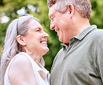 Senior, couple and love smile of marriage, retirement and care in nature for an anniversary. Happy elderly woman and man loving summer spending quality time together feeling romantic and happiness