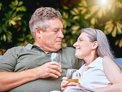 Buy stock photo Love, juice and senior couple talking while relaxing outdoor in the garden at their home in summer. Happy, conversation and elderly man and woman in retirement resting together at their house.