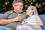 Senior couple, drink and relax while on retirement, love and happy together on vacation and outdoor. Elderly, man and woman enjoy retirement, romantic and care in relationship with relaxing lifestyle