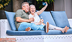 Selfie, relax and senior couple with a drink on an outdoor sofa on holiday in Costa Rica. Retirement, alcohol and happy elderly man and woman with a phone for photo, smile and memory on a vacation