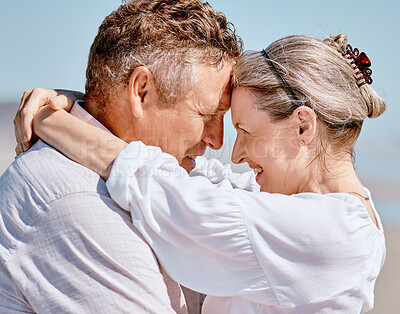 Buy stock photo Love, romance and beach with a senior couple hugging outdoor in nature while enjoying a retirement vacation. Travel, summer and together with a mature man and woman pensioner bonding on the coast