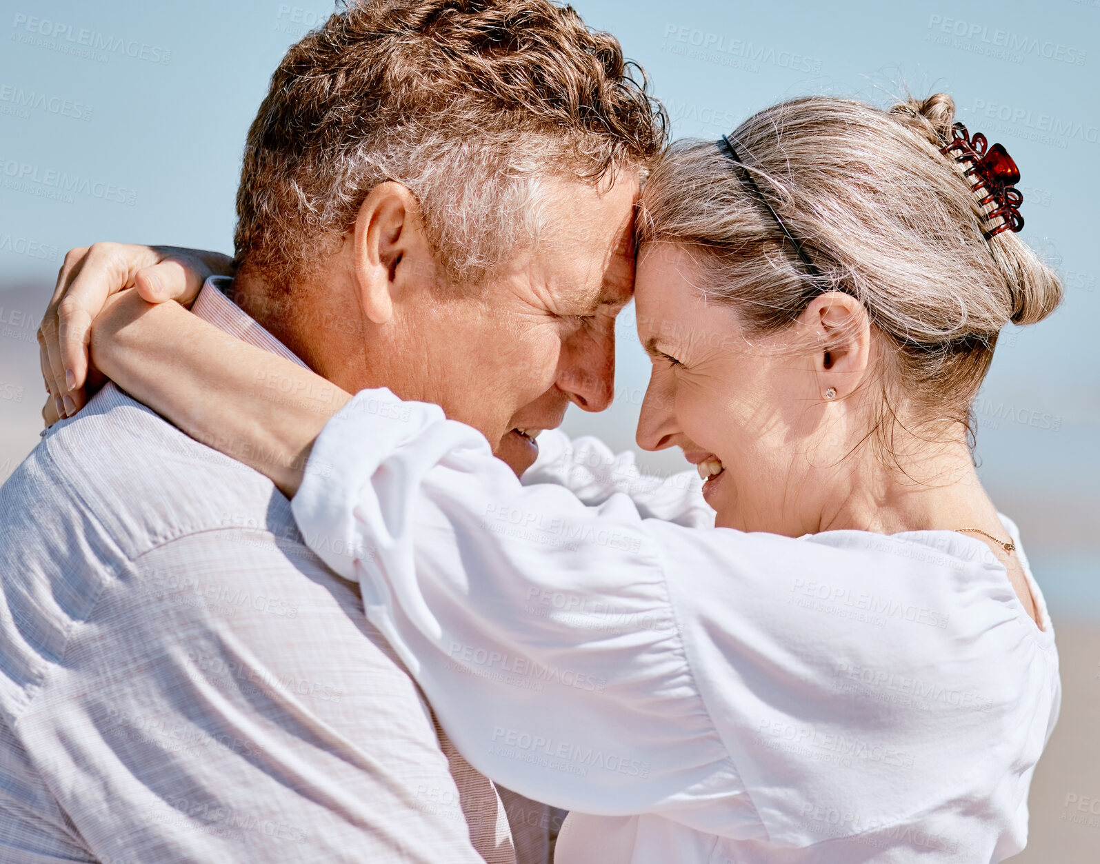 Buy stock photo Love, romance and beach with a senior couple hugging outdoor in nature while enjoying a retirement vacation. Travel, summer and together with a mature man and woman pensioner bonding on the coast