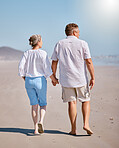 Beach, summer and senior couple walking for exercise while on vacation, adventure or journey. Love, holding hands and elderly man and woman pensioners on walk while on retirement holiday in Australia