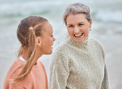 Buy stock photo Family, children and beach with a senior woman and girl child bonding by the sea in nature. Kids, love and retirement with a grandmother and grandchild spending time together by the ocean outdoor