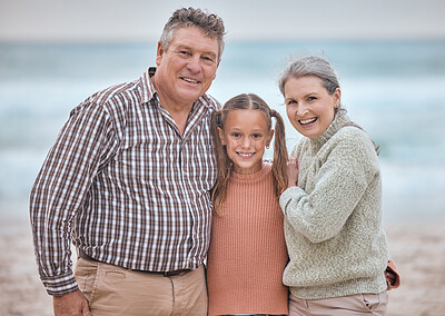 Buy stock photo Happy family, portrait and girl at the beach with grandparents relax, bond and smile, hug and love. Happy, seniors and child enjoy family time in nature, seaside and ocean fun on vacation together