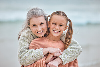 Buy stock photo Hug, beach and portrait of girl and grandma on vacation, holiday or trip. Family love, care and happy grandmother bonding with kid, having fun and enjoying quality time together outdoors on seashore.