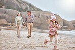 Grandparents, running kid and beach holiday, vacation and relax together for bonding, freedom or family time outdoors. Portrait of excited, happy and young girl child at ocean sand with senior family